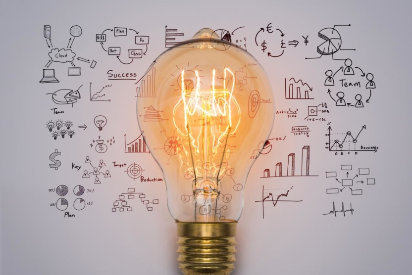 marketing strategy - lightbulb surrounded by charts and graphs