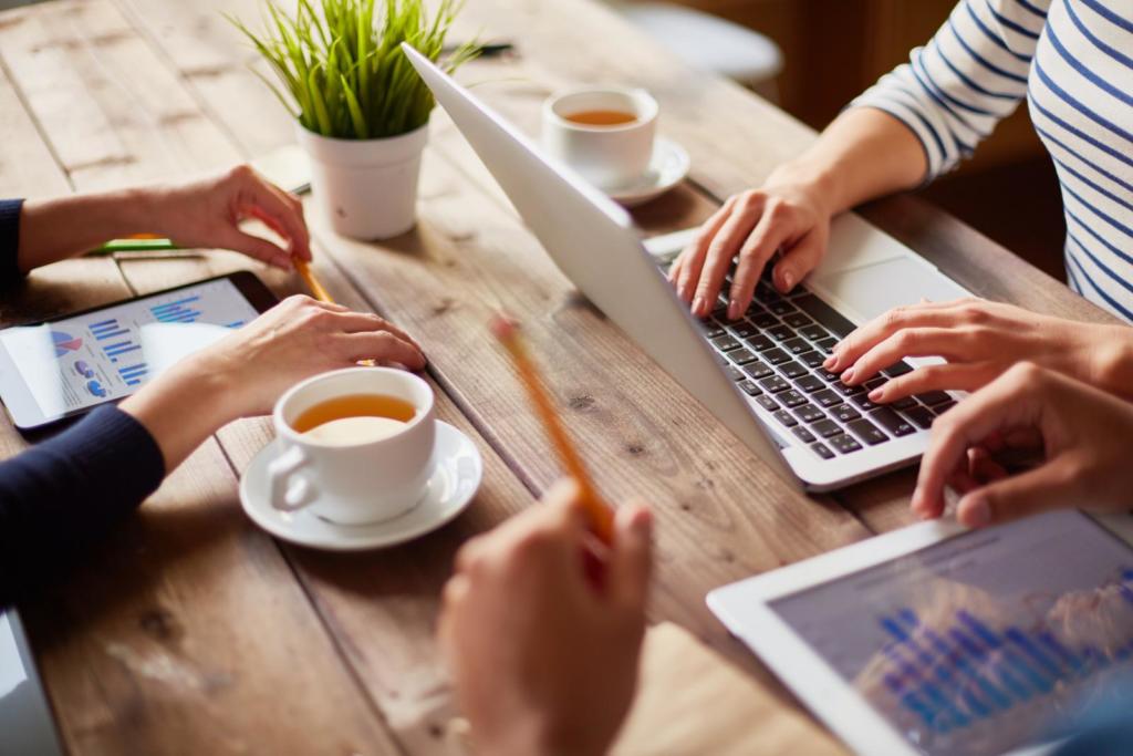 people using various devices at a table