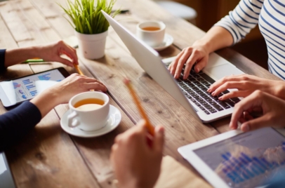 people using various devices at a table