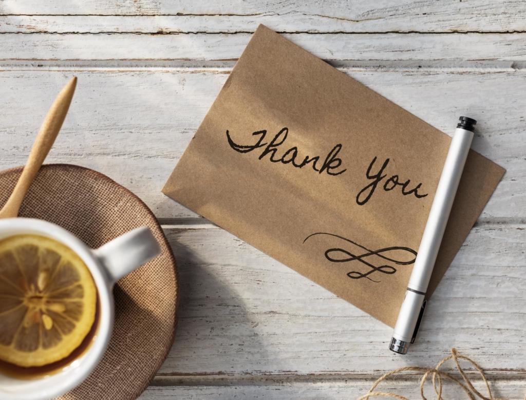cup of lemon tea next to note with handwritten thank you