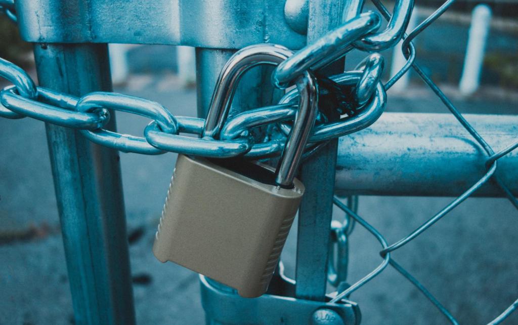 locked padlock and chain on a gate