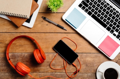 headphones phone and laptop on desk