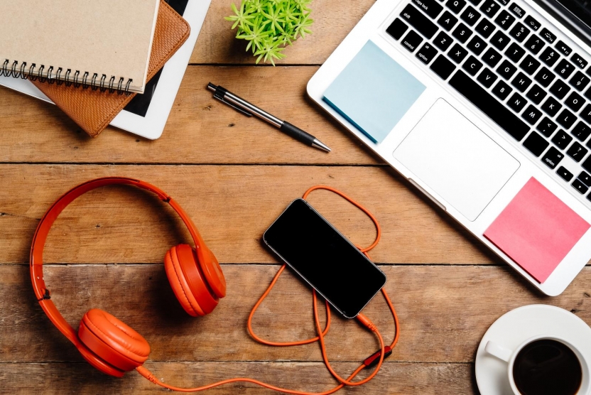 headphones phone and laptop on desk