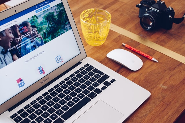 A laptop with the Facebook ads website on the screen, representing the process of boosting service businesses