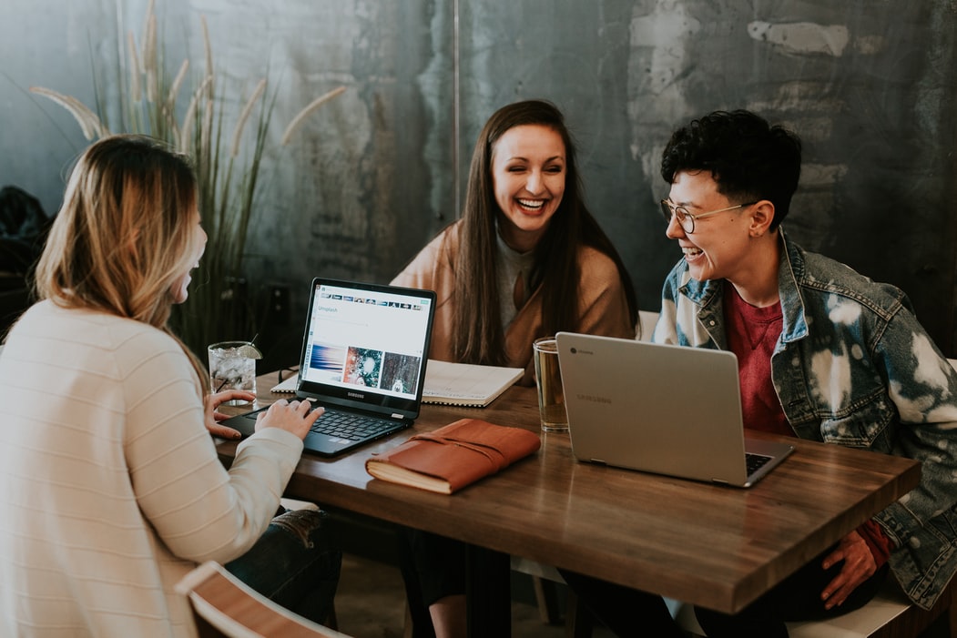 Three young people using laptops