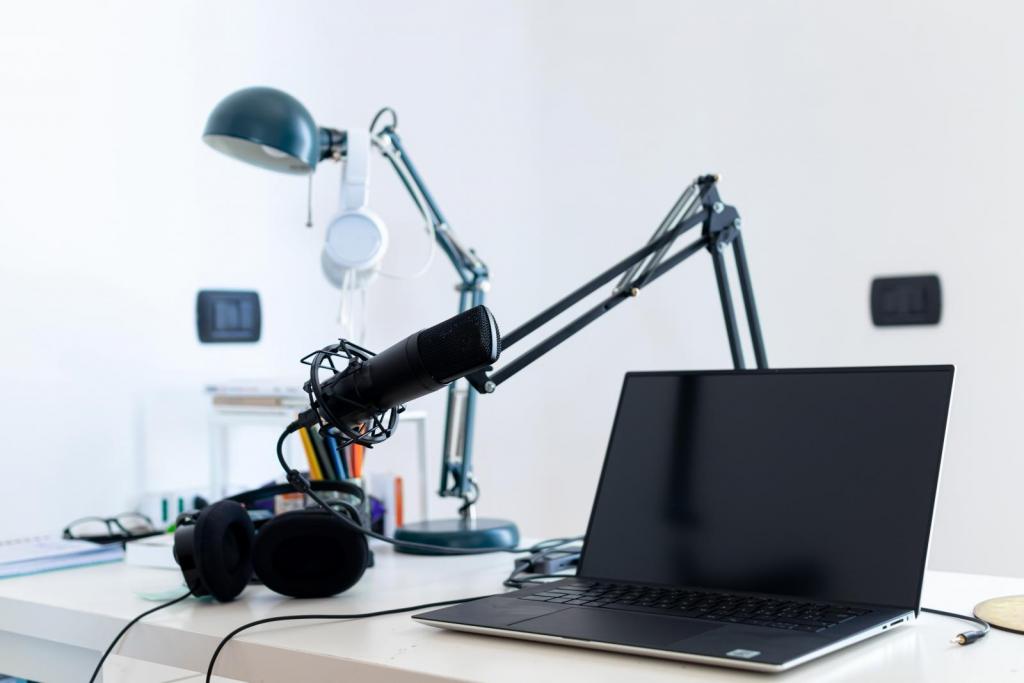 webinar equipment - headphones, microphone, laptop on a desk