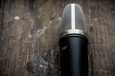 social listening concept - microphone on a wood table