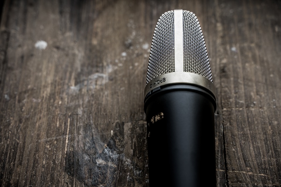 social listening concept - microphone on a wood table