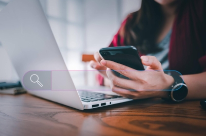 woman using laptop and phone