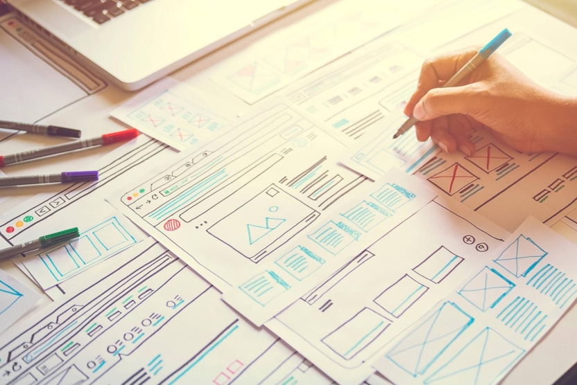 papers featuring website strategy design concepts on a desk