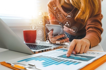 woman using laptop and phone for social media