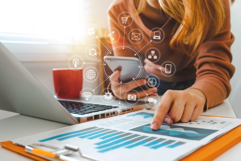 woman using laptop and phone for social media