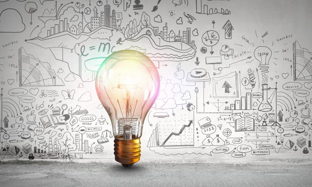 business growth strategy concept - lightbulb in front of a board full of ideas