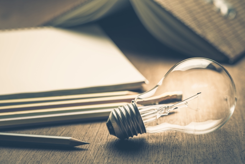 content marketing concept - notebook with lit lightbulb