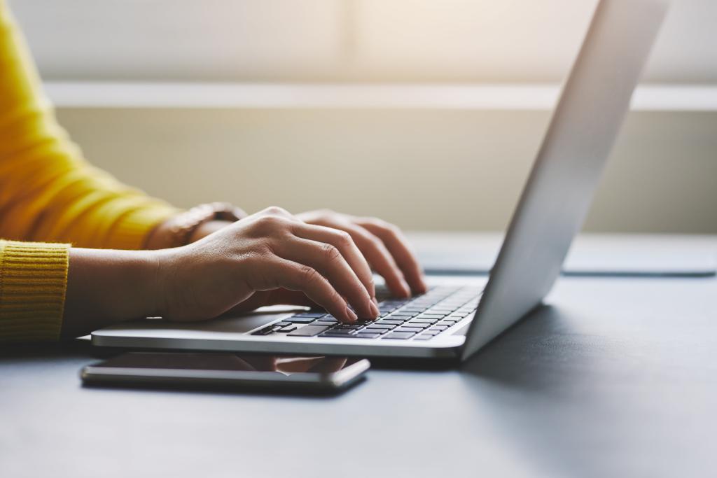 person typing on a laptop