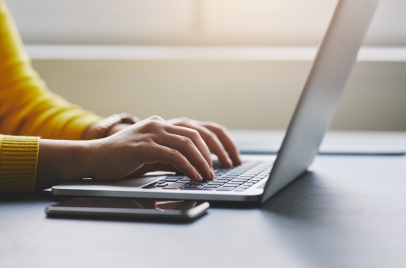 person typing on a laptop