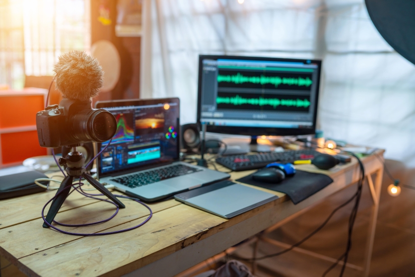 camera, microphone, and laptop on a desk for video creation