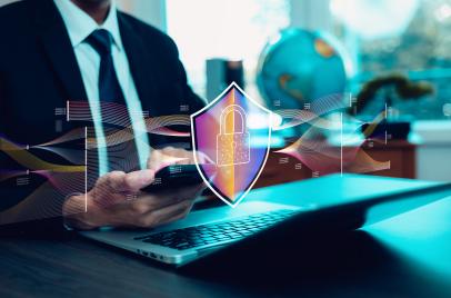 man holding smartphone with security icon in front of phone