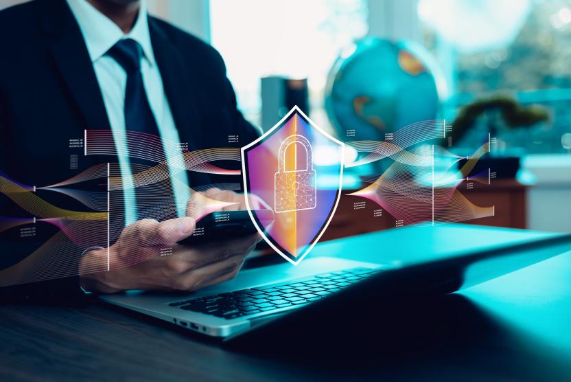 man holding smartphone with security icon in front of phone