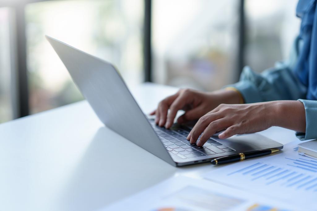 woman typing on a laptop