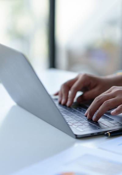 woman typing on a laptop