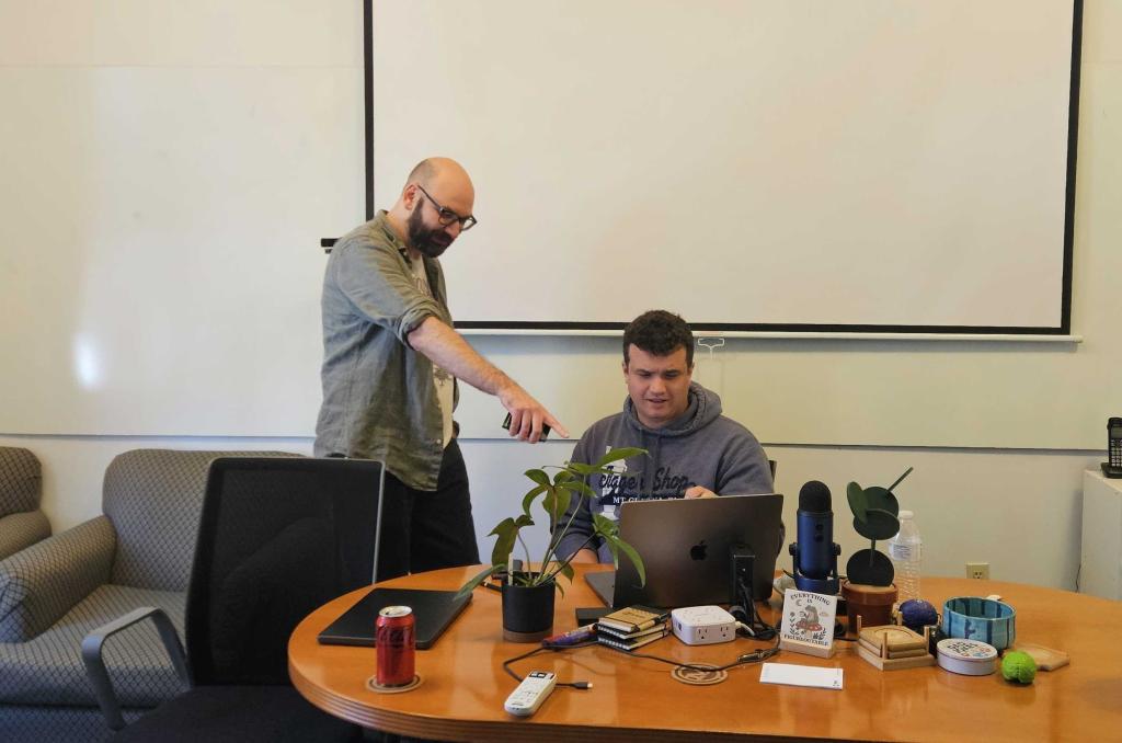 A senior developer showing a junior developer a mistake they made